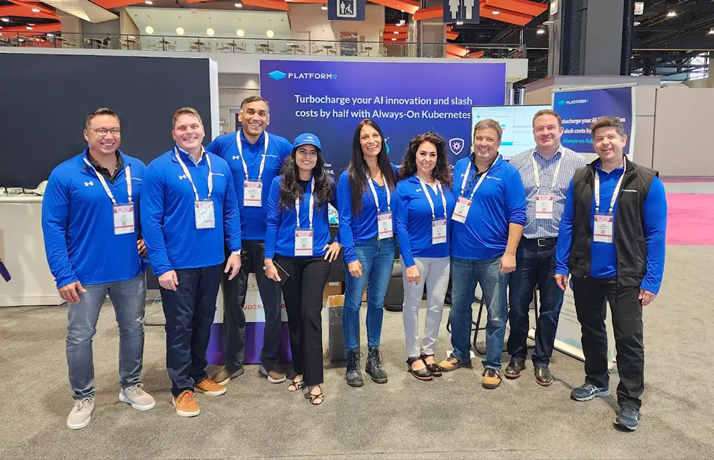 A group photo of the Platform9 team at the KubeCon event